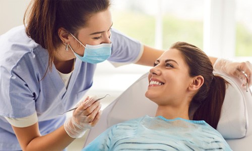 Patient smiling at dental team member